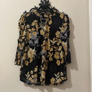 Beautiful light weight blouse with a floral design.